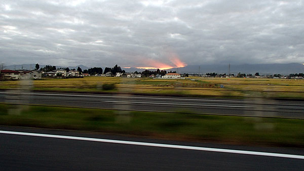 厚い雲の隙間から夕陽の光がまるで噴出す炎の様に見える